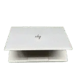 White HP Elitebook 640 G9 laptop with logo, closed, on a green background.