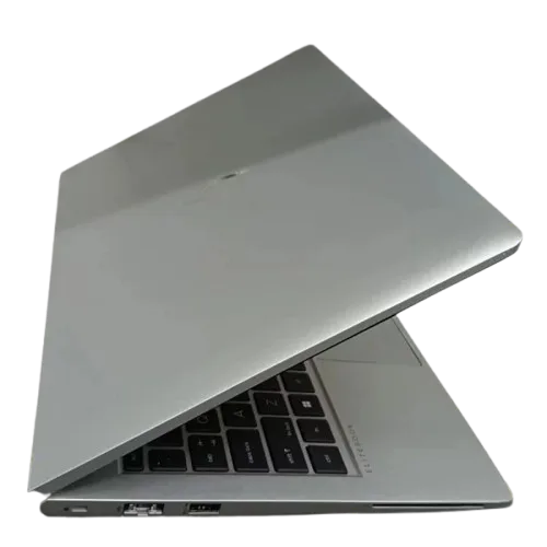 Silver laptop with partially open lid showing keyboard and ports.