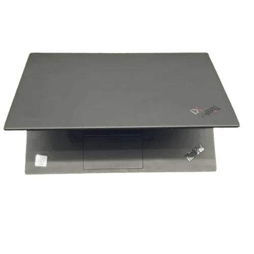 Lenovo ThinkPad X1 Carbon laptop with closed lid and keyboard visible.