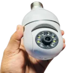 Hand holding a white wireless IP camera with infrared LEDs for night vision.
